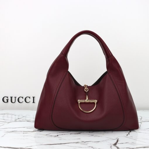 Softbit Maxi Shoulder Bag. Authentic quality luxury bag crafted in genuine leather comes with authenticity card, dust bag and gift bag. Icon Reimagined: Effortless Luxury with a Modern Bit of Bold. *ucci’s timeless heritage meets contemporary ease in the new Softbit Shoulder Bag. Crafted from supple grained leather with a luxuriously rich texture, this piece balances sophistication and function effortlessly. At its heart lies an oversized half-horsebit — a bold reinterpretation of the House’s iconic detail — accenting the magnetic closure with statement appeal. With its relaxed silhouette and refined craftsmanship, the Softbit is the perfect companion for those who favor effortless elegance with a modern edge.