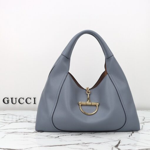 Softbit Maxi Shoulder Bag. Authentic quality luxury bag crafted in genuine leather comes with authenticity card, dust bag and gift bag. Icon Reimagined: Effortless Luxury with a Modern Bit of Bold. *ucci’s timeless heritage meets contemporary ease in the new Softbit Shoulder Bag. Crafted from supple grained leather with a luxuriously rich texture, this piece balances sophistication and function effortlessly. At its heart lies an oversized half-horsebit — a bold reinterpretation of the House’s iconic detail — accenting the magnetic closure with statement appeal. With its relaxed silhouette and refined craftsmanship, the Softbit is the perfect companion for those who favor effortless elegance with a modern edge.